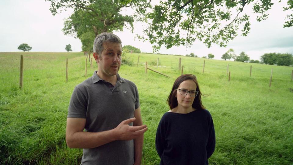  Dyfan and Carys Walter standing in green fields