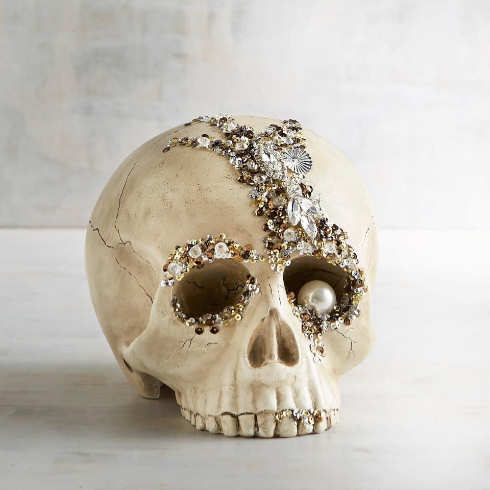 <p>If it’s possible for a decoration to be scary and beautiful at once, this one accomplishes it.</p> <p><strong>Shop now:</strong> Bejeweled Skull Halloween Decor, $20. <a rel="nofollow noopener" href="https://www.pier1.com/bejeweled-skull-halloween-decor/3482280.html?cgid=halloween-decorations#nav=left&origin=gridswatch" target="_blank" data-ylk="slk:pier1.com;elm:context_link;itc:0;sec:content-canvas" class="link ">pier1.com</a></p>