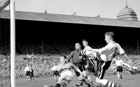 Blackpool's Stanley Mortensen (left) scores his second of three goals against Bolton Wanderers, during their 1953 FA Cup Final football match at Wembley Stadium, in London. Blackpool won 4-3 - Credit: PA