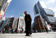 Homeless Makoto Shinbo poses for the camera in front of high-risen buidlings nearby Miyashita park where he lives in Tokyo, Japan, March 7, 2017.REUTERS/Kim Kyung-Hoon