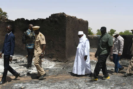 Mali's President Ibrahim Boubacar Keita inspects the site of an attack by gunmen on Fulani herders in Ogossagou, Mali March 25, 2019. Picture taken March 25, 2019. Malian Presidency/Handout via Reuters