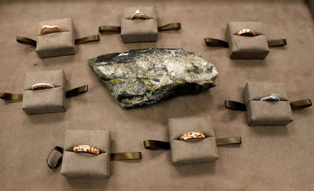 Rings made from Welsh Gold are displayed around a gold-bearing rock at the Clogau office in Bodelwyddan, North Wales, Britain, March 12, 2018. REUTERS/Phil Noble