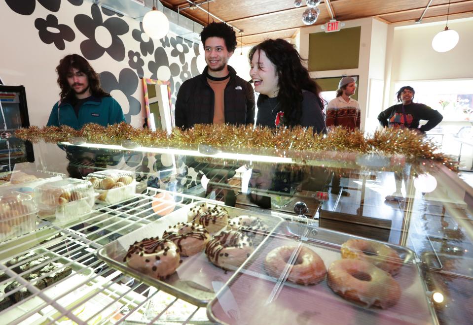 (L-R). Aidan Goldberg, Miles Greenblatt and Hannah Devine-Rader selected items at the newly opened The Flour Shoppe vegan bakery in Louisville, Ky. on Feb. 19, 2023.  