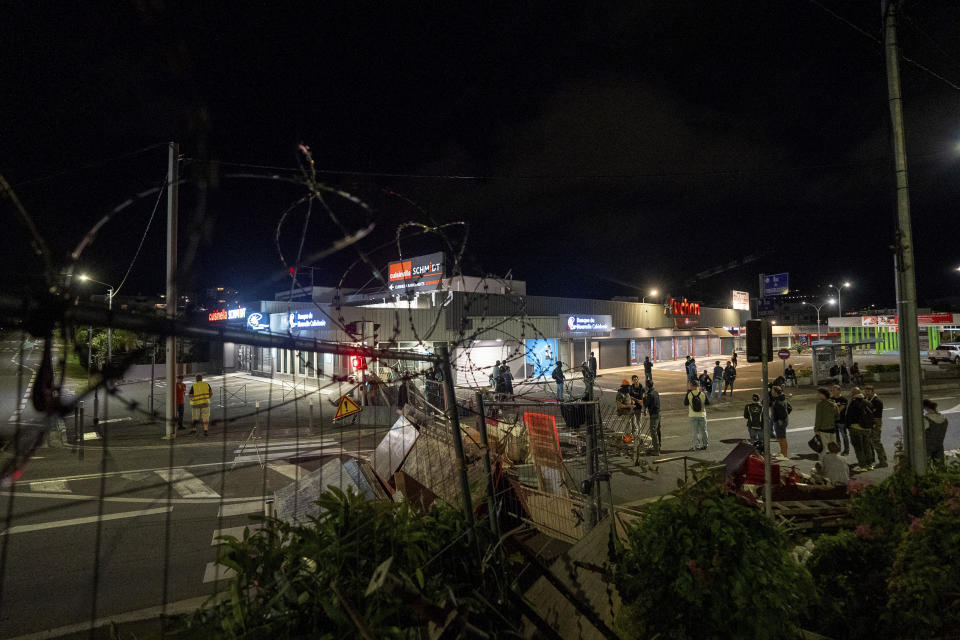 Residents stand in a blockade in Noumea, New Caledonia, Wednesday May, 15, 2024. Violence is raging across New Caledonia for the third consecutive day and France has imposed a state of emergency in the French Pacific territory. (AP Photo/Nicolas Job)
