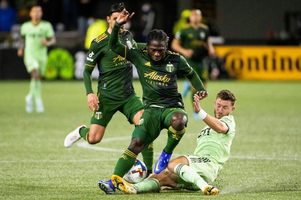 Austin FC's Jon Gallagher tackles Portland forward Yimmi Chara during the Timbers' 1-0 win March 12. Gallagher says he loves playing defense. "There’s a bit of pride to guarding the other team’s best player," he said.