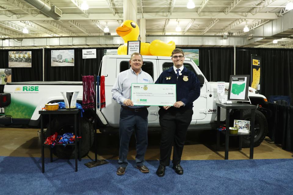 Sunrise President/CEO George D. Secor (left) presents a $250 donation for the Buckeye Central FFA Chapter to Chris Hiler.