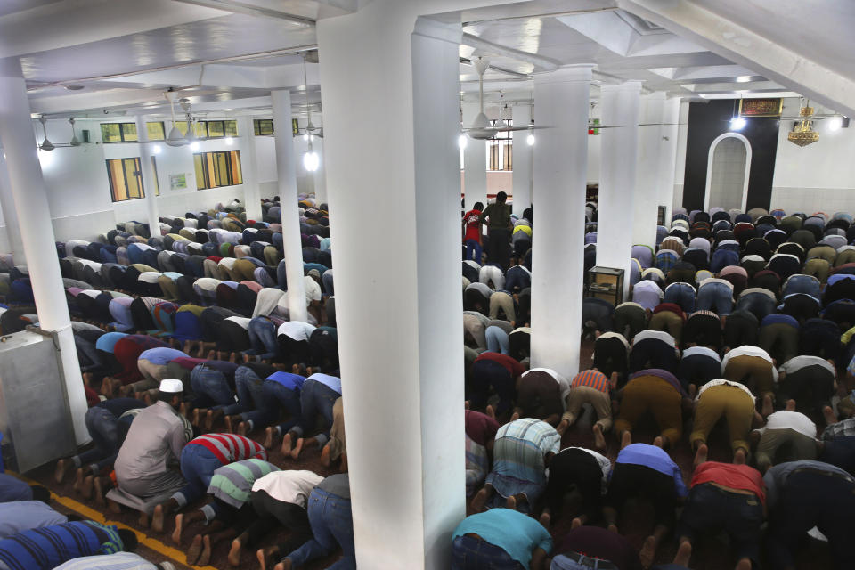 Sri Lankan Muslims offer Friday prayers inside a mosque, in Colombo, Sri Lanka, Friday, April 26, 2019. Across Colombo, there was a visible increase of security as authorities warned of another attack and pursued suspects that could have access to explosives. Authorities had told Muslims to pray at home rather than attend communal Friday prayers that are the most important religious service for the faithful. At one mosque in Colombo where prayers were still held, police armed with Kalashnikov assault rifles stood guard outside. (AP Photo/Manish Swarup)