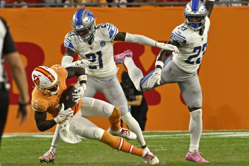 Tampa Bay Buccaneers wide receiver Chris Godwin (L) makes a catch in front of Detroit Lions safety Tracy Walker III (C) on Sunday at Raymond James Stadium in Tampa, Fla. Photo by Steve Nesius/UPI