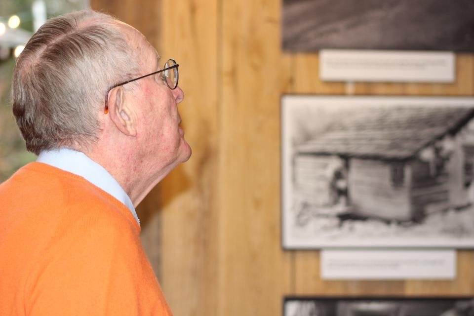 Former University of Tennessee president Lamar Alexander looks at some of the photos of the Appalachian people who were impacted by the construction of Norris Dam. In addition to bringing jobs and electricity to the area, it forced many of them to relocate.