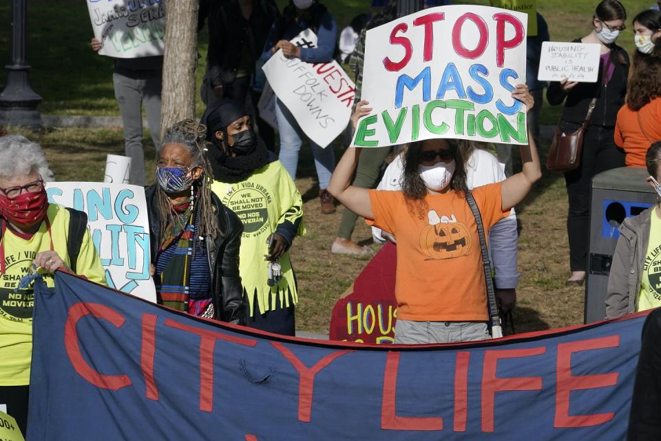 Protesters display placards during a demonstration to support for tenants and homeowners at risk of eviction in Boston on Oct. 11.