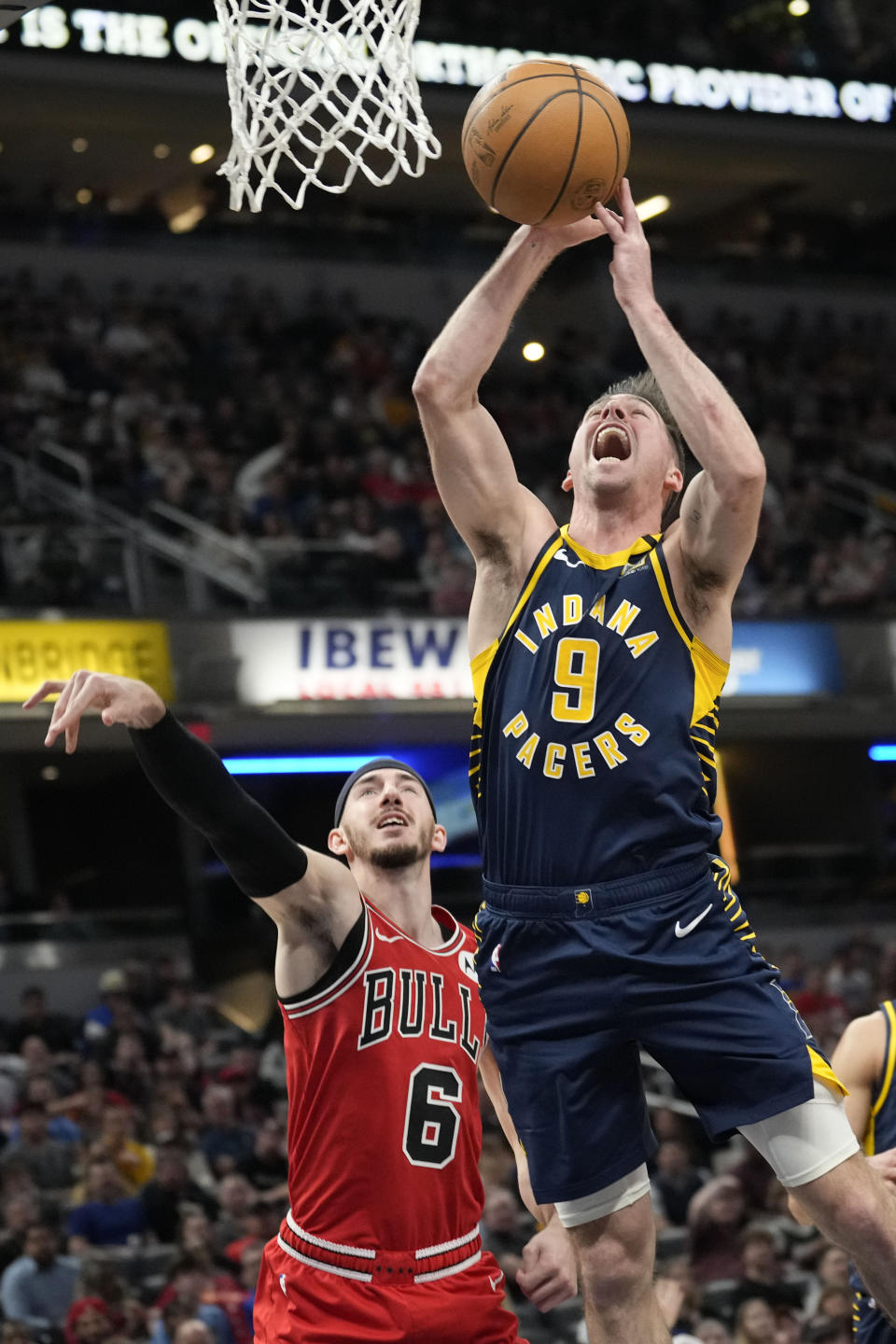 Indiana Pacers guard T.J. McConnell (9) loses the ball after being fouled by Chicago Bulls guard Alex Caruso (6) during the first half of an NBA basketball game in Indianapolis, Wednesday, March 13, 2024. (AP Photo/AJ Mast)