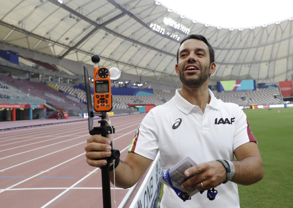 Dr. Paolo Adami explains the use of a heat measuring sensor at the World Athletics Championships in Doha, Qatar, Monday, Sept. 30, 2019. There are around 200 endurance athletes at the world championships swallowing a capsule as part of an IAAF research project on the effects of heat. They couldn't have picked a better time or place in Doha, where the temperatures are soaring. The data could be used to help athletes prepare for the Tokyo Games in less than a year and where conditions are expected to be every bit as stifling. (AP Photo/Petr David Josek)