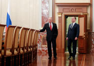 Russian President Vladimir Putin, right, and Russian Prime Minister Dmitry Medvedev talk to each other prior to a cabinet meeting in Moscow, Russia, Wednesday, Jan. 15, 2020. The Tass news agency reports Wednesday that Russian Prime Minister Dmitry Medvedev submitted his resignation to President Vladimir Putin. Russian news agencies said Putin thanked Medvedev for his service but noted that the prime minister's Cabinet failed to fulfill all the objectives set for it. (Dmitry Astakhov, Sputnik, Government Pool Photo via AP)