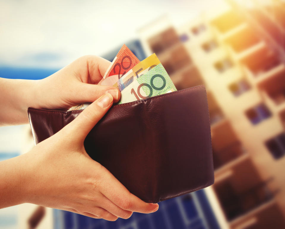 australian money in wallet on real estate background