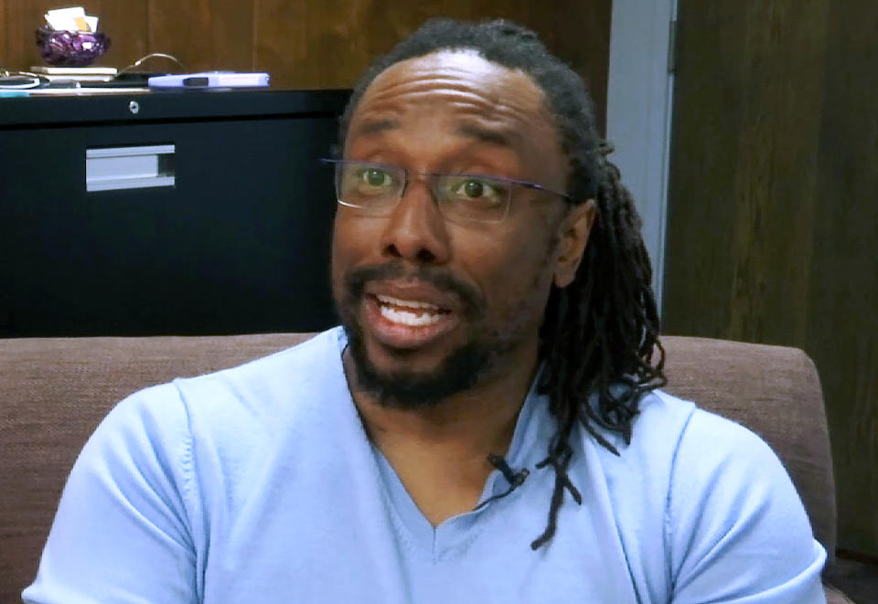 In this Thursday, June 20, 2019, image made from video, Chris Gilliard speaks during an interview with The Associated Press at an office in Dearborn, Mich. Gilliard is an English professor at Michigan’s Macomb Community College and a prominent critic of Ring and other technology that he says can reinforce race barriers and discrimination. (AP Photo/Mike Householder)