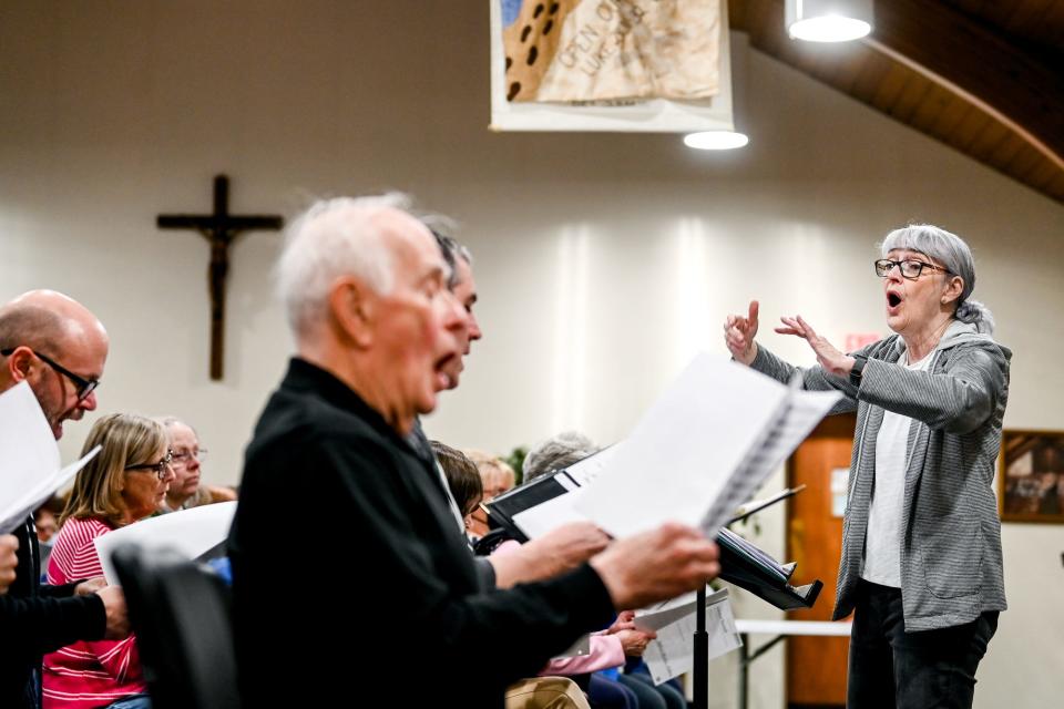 Delta Community Choir director Ellen McKenzie, right, leads a practice on Monday, April 24, 2023, at St. David's Episcopal Church in Lansing.