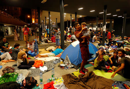FILE PHOTO: Asylum seekers wait outside a train station in Budapest, Hungary, August 28, 2015. REUTERS/Laszlo Balogh/File Photo