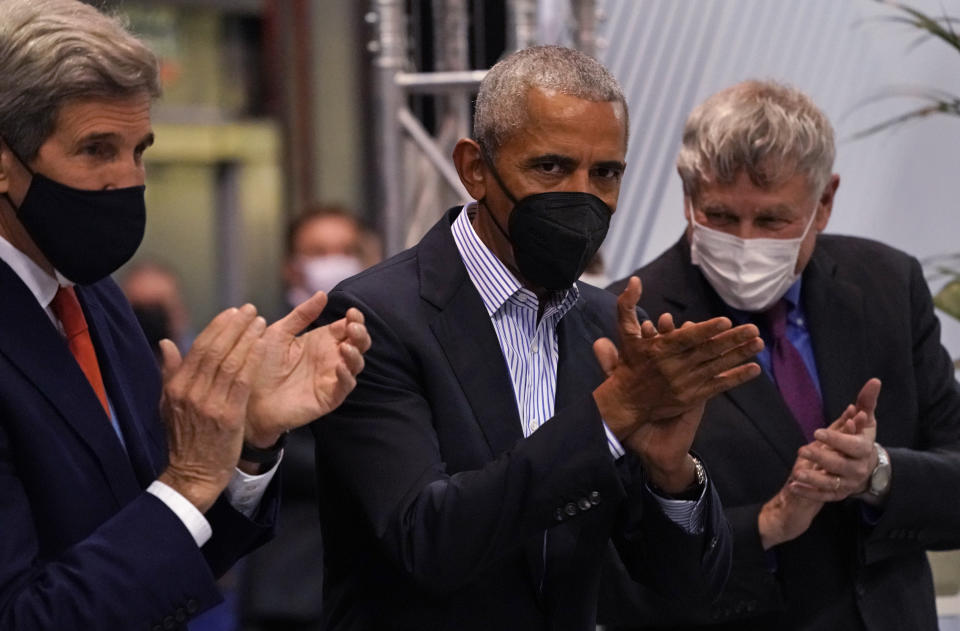 Former U.S. President Barack Obama and John Kerry, United States Special Presidential Envoy for Climate applaud members of the US delegation at the US Center at the COP26 U.N. Climate Summit in Glasgow, Scotland, Tuesday, Nov. 9, 2021. The U.N. climate summit in Glasgow has entered it's second week as leaders from around the world, are gathering in Scotland's biggest city, to lay out their vision for addressing the common challenge of global warming. (AP Photo/Alberto Pezzali)