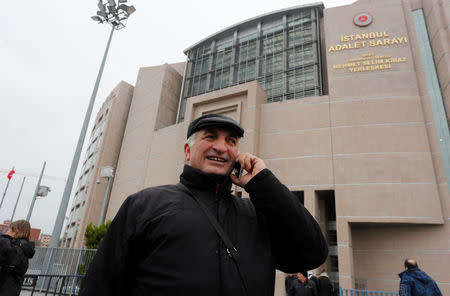 Ali Riza Tolu, father of imprisoned German journalist Mesale Tolu, talks with his mobile phone in front of the Justice Palace, the Caglayan courthouse, in Istanbul, Turkey, December 18, 2017. REUTERS/Osman Orsal