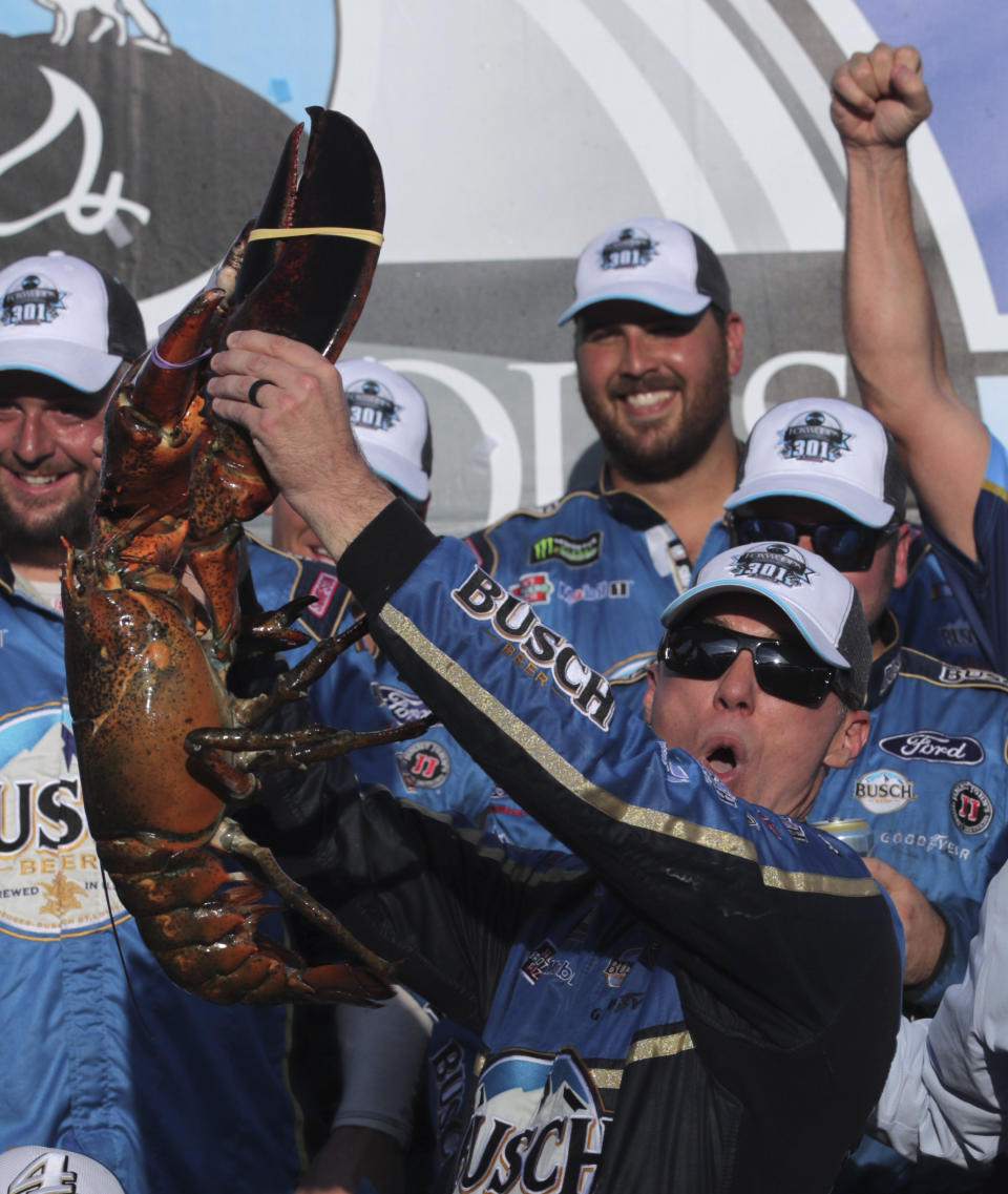 Kevin Harvick hoists a giant lobster in victory lane after winning a NASCAR Cup Series auto race at New Hampshire Motor Speedway in Loudon, N.H., Sunday, July 21, 2019. (AP Photo/Charles Krupa)