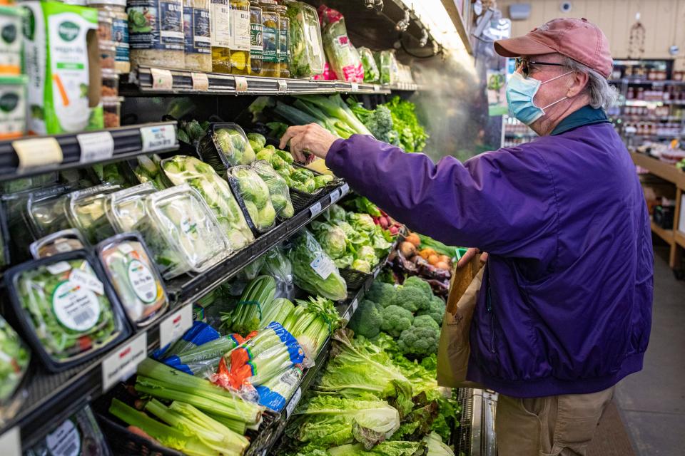 Joe Blocker browses produce at Paul's Fruit Market on Taylorsville Road. May 11, 2020