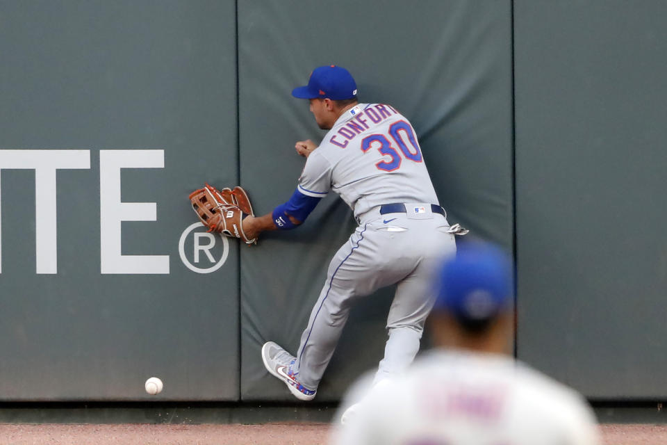 New York Mets right fielder Michael Conforto can't get to a ball hits for an RBI double by Atlanta Braves' Tyler Flowers during the second inning of a baseball game Saturday, Aug. 1, 2020, in Atlanta. (AP Photo/John Bazemore)