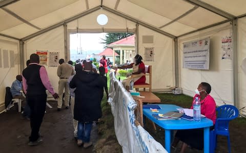 An Ebola screening checkpoint where people crossing from Congo go through foot and hand washing with a chlorine solution and have their temperature taken, at the Bunagana border crossing with Congo, in western Uganda - Credit: Ben Wise/International Rescue Committee&nbsp;