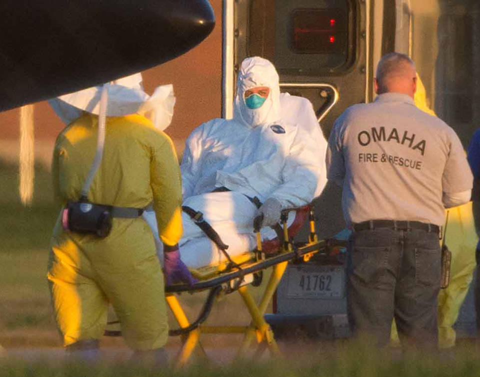 Ashoka Mukpo is lifted into an ambulance after arriving in Omaha, Neb., on Oct. 6, 2014. (AP/The World-Herald)