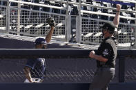 Right field umpire Manny Gonzalez calls an out after Tampa Bay Rays right fielder Manuel Margot fell over a right field wall after catching a foul ball by Houston Astros center fielder George Springer during the second inning in Game 2 of a baseball American League Championship Series, Monday, Oct. 12, 2020, in San Diego. (AP Photo/Jae C. Hong)