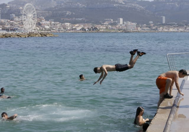 Children dive into the Mediterranean Sea in Marseille, southern France