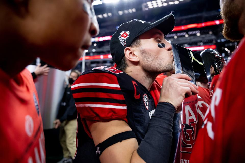 Utah Utes wide receiver Britain Covey kisses the Pac-12 championship trophy
