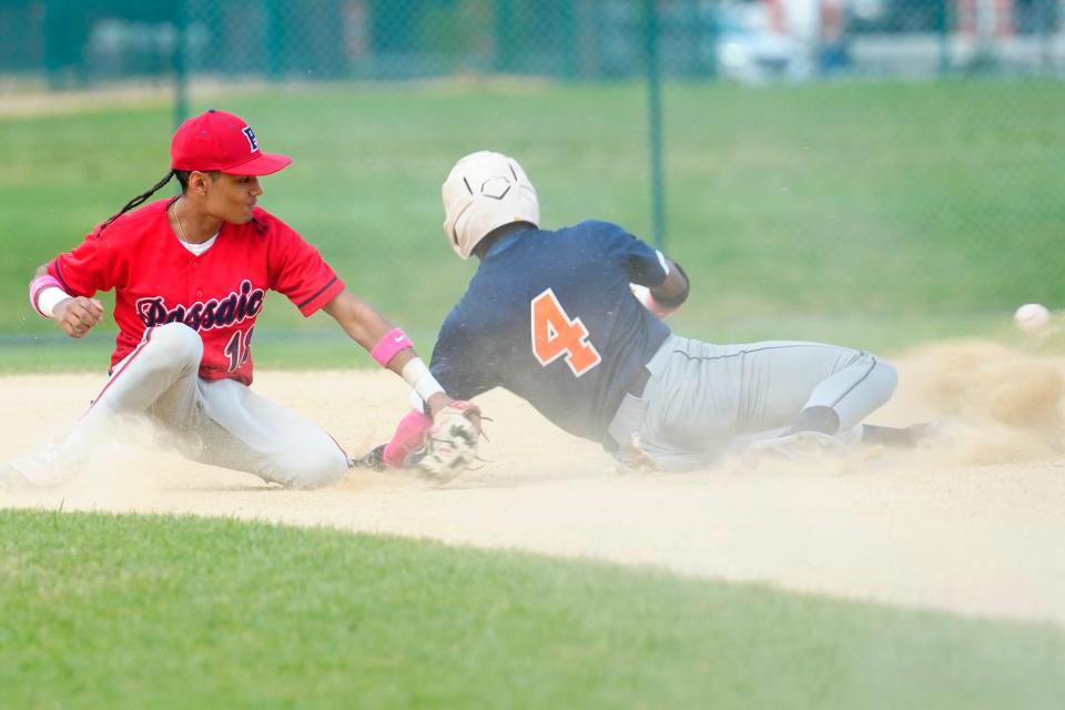 Wilbert Polanco, of Passaic, is unable to handle the throw to second base as Kairo Reyes,,of Eastside, steals second base, Monday, April 29, 2024, in Paterson.