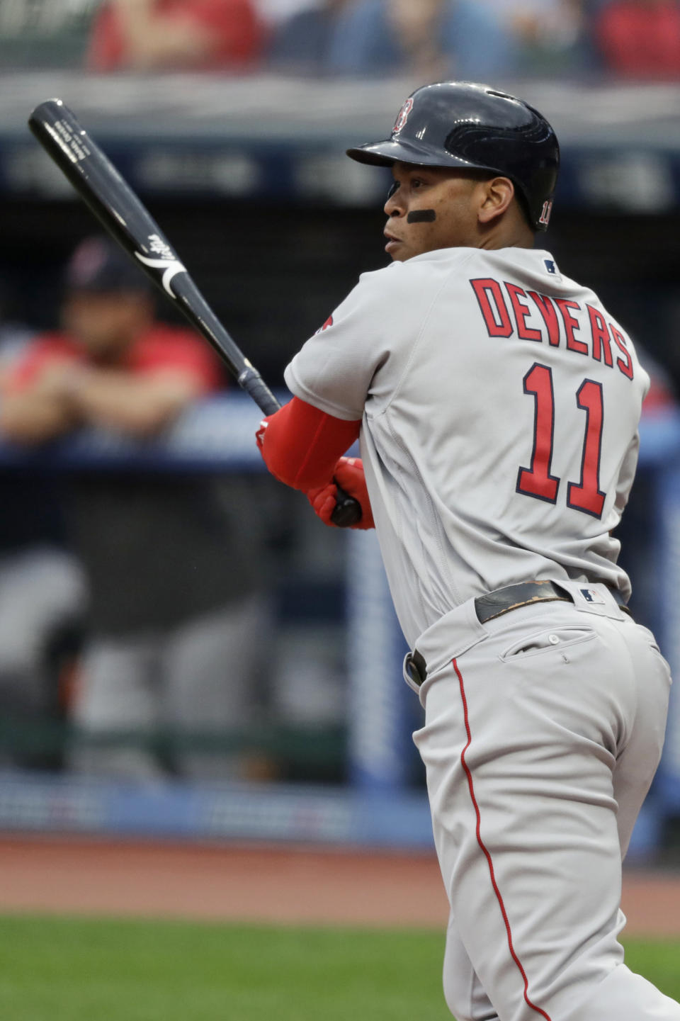 Boston Red Sox's Rafael Devers watches his RBI double during the first inning of the team's baseball game against the Cleveland Indians, Tuesday, Aug. 13, 2019, in Cleveland. (AP Photo/Tony Dejak)