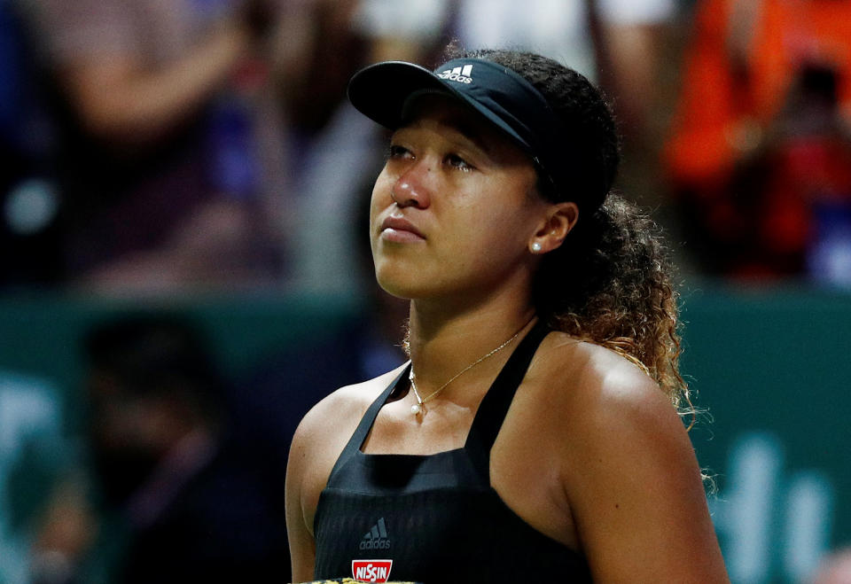 A tearful Naomi Osaka retires from her match against Kiki Bertens with a left hamstring injury. (PHOTO: Reuters/Edgar Su)