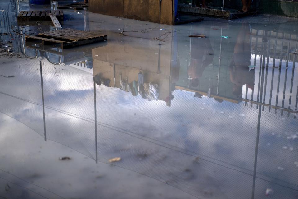 Stagnant water pools in the bathing and portable toilet area of a sports complex where more than 5,000 Central American migrants are sheltering in Tijuana, Mexico, Wednesday, Nov. 28, 2018. As Mexico wrestles with what to do with the thousands of people camped out in the border city of Tijuana, President-elect Andres Manuel Lopez Obrador's government signaled that it would be willing to house the migrants on Mexican soil while they apply for asylum in the United States, a key demand of U.S. President Donald Trump. (AP Photo/Ramon Espinosa)