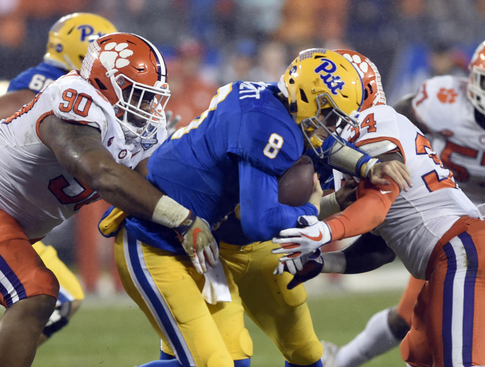 Pittsburgh's Kenny Pickett (8) is sacked by Clemson's Dexter Lawrence (90) and Kendall Joseph (34) in the first half of the Atlantic Coast Conference championship NCAA college football game in Charlotte, N.C., Saturday, Dec. 1, 2018. (AP Photo/Mike McCarn)
