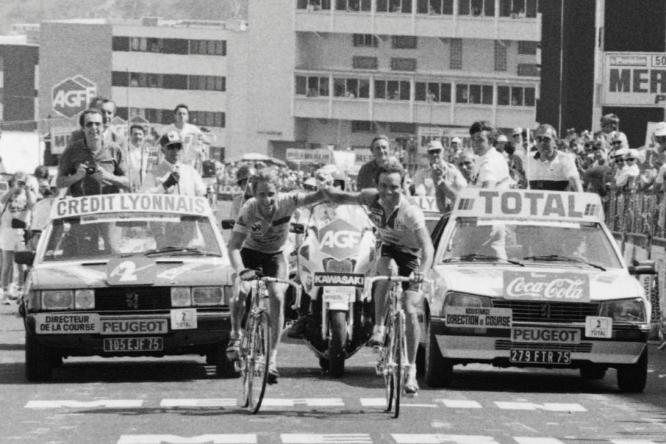 American Greg Lemond, left, and French teammate Bernard Hinault cross the line (AFP via Getty Images)