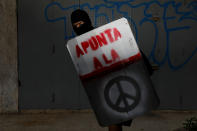 <p>A demonstrator holding a rudimentary shield that reads “Aim to the”, poses for a picture before a rally against Venezuelan President Nicolas Maduro’s government in Caracas, Venezuela, June 17, 2017. He said: “I protest to have a better Venezuela… Because today most of the young people graduate and have no chance of fulfilling their goals in the country. Venezuelans don’t want any more dictatorship or repression, we want freedom.” (Photo: Carlos Garcia Rawlins/Reuters) </p>