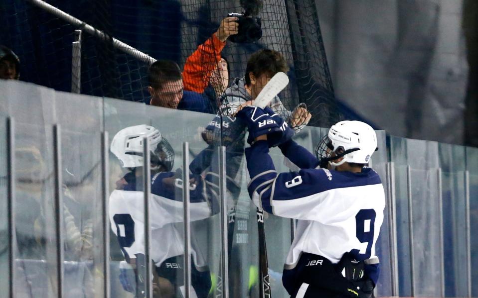 Jack Buonato of Manasquan celebrates with fans after scoring a goal against Howell, during ice hockey game at Jersey Shore Arena, Wall Twp.,N.J.Wednesday, Dec. 13, 2023