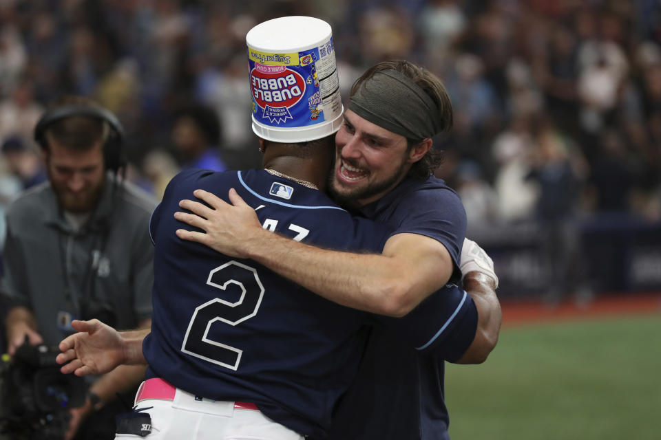 Tampa Bay Rays' Yandy Diaz (2) celebrates with teammate Josh Lowe after hitting a walk off two-run home run against the Seattle Mariners during a baseball game Saturday, Sept. 9, 2023, in St. Petersburg, Fla. (AP Photo/Scott Audette)