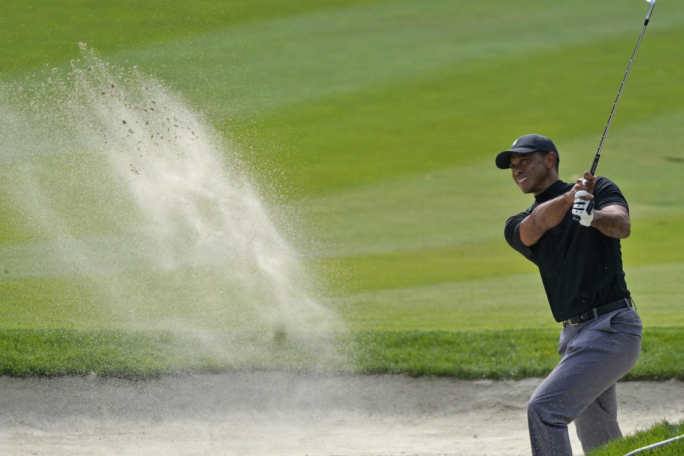 Tiger Woods hits from the bunker off the 13th fairway during the first round of the Zozo Championship golf tournament Thursday, Oct. 22, 2020, in Thousand Oaks, Calif. (AP Photo/Marcio Jose Sanchez)