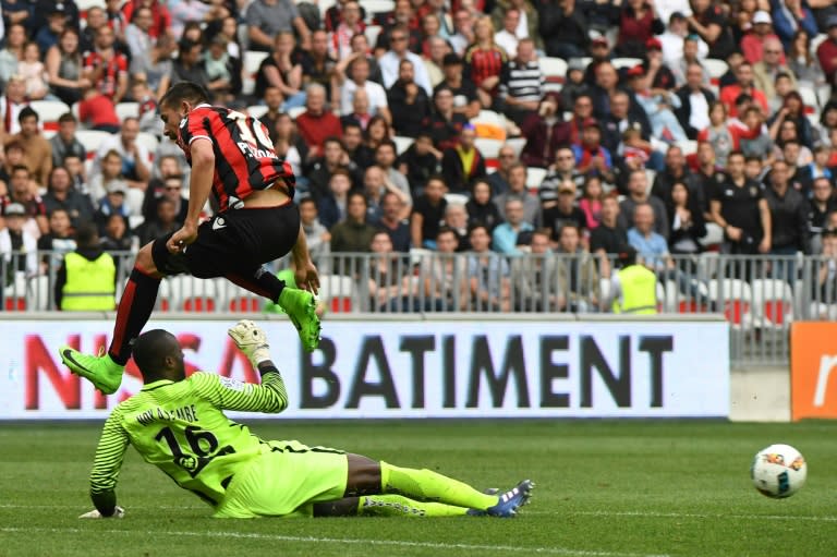 Nice's Mickael Le Bihan (Up) vies with Nancy's goalkeeper Guy-Roland Ndy Assembe at the Allianz Riviera Stadium, in Nice, on April 15, 2017