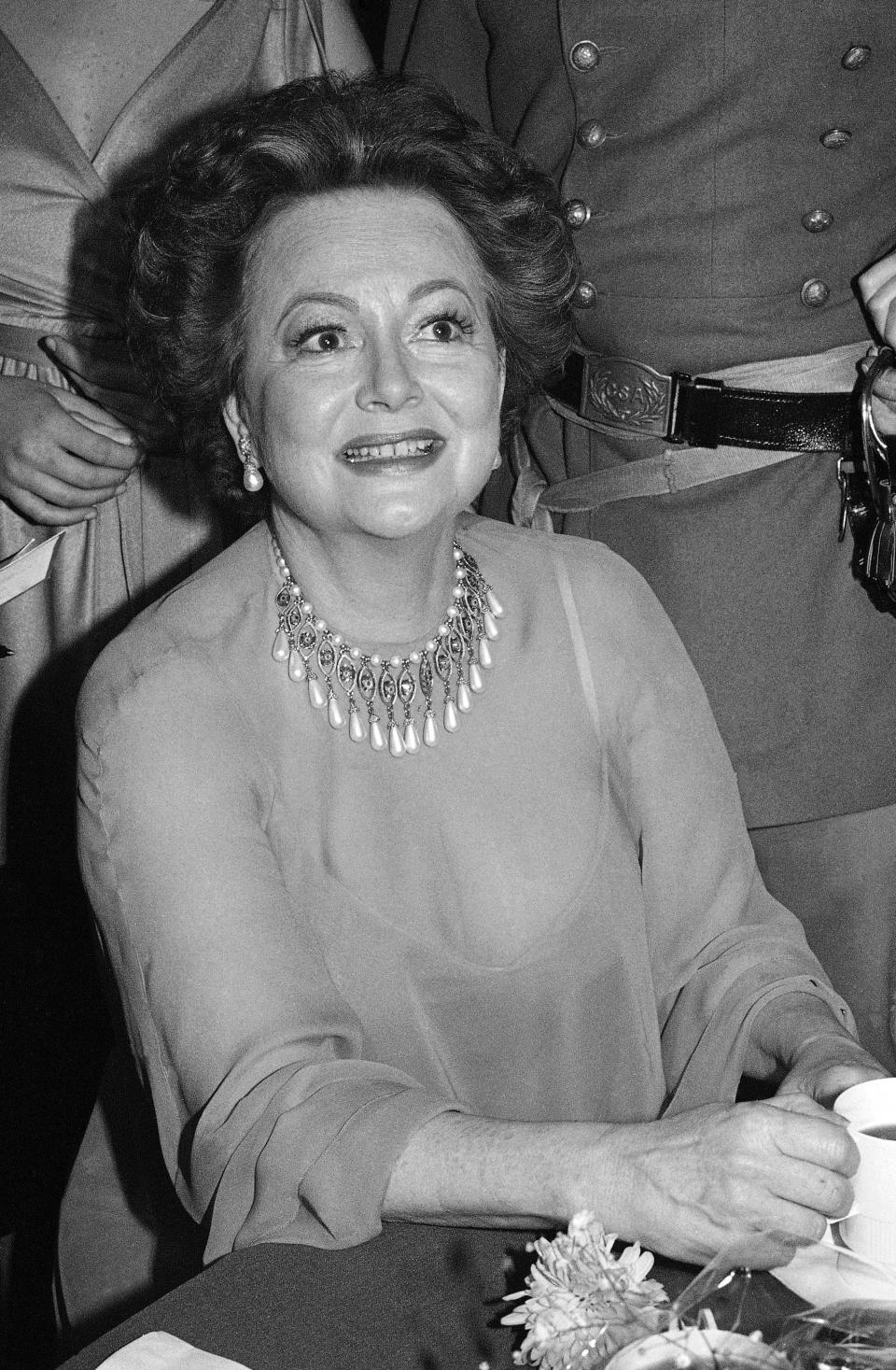 FILE - In this file photo dated Dec. 28, 1979, actress Olivia De Havilland at Hollywood dinner party. Olivia de Havilland, Oscar-winning actress has died, aged 104 in Paris, publicist says Sunday July 26, 2020. (AP Photo/ Nick Ut, FILE)