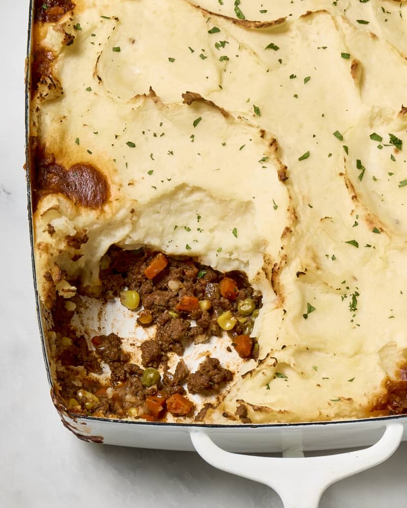 overhead shot of shepards pie with a scoop taken from the bottom left corner.