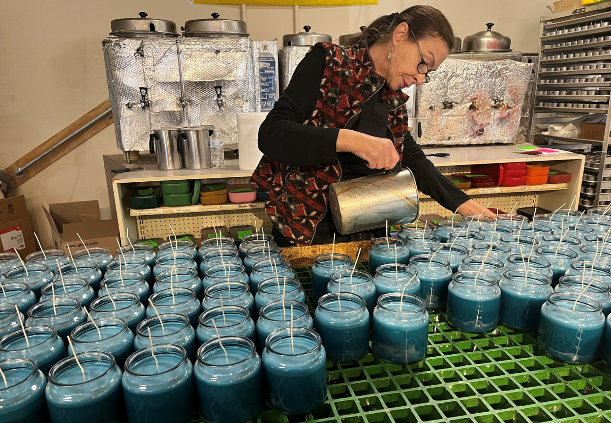 Julia LaViolette pours the mixture for Door County Candle Co.'s Beachside candles. The company is selling the 16-ounce size of the Beachside as a fundraiser for American Red Cross relief efforts for those affected by Hurricane Ian.