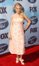 A year after her “Idol” victory, Underwood returned for the finale showing her passion for pink. The ill-fitting ankle-length strapless dress, in a petal-pink hue with silver specs, featured appliqué flowers all over it. But the true pièce de résistance were her shoes. They also featured fluffy bows. It was a bit much. (5/24/2006)