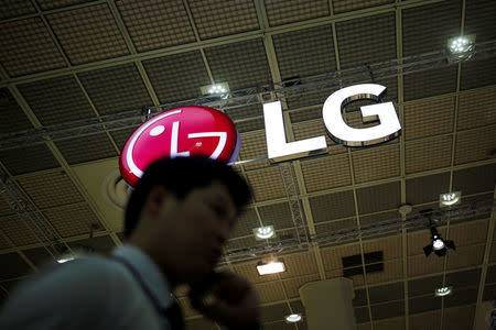 A man talking on his phone walks past the logo of LG Electronics during Korea Electronics Show 2016 in Seoul, South Korea, October 27, 2016. REUTERS/Kim Hong-Ji