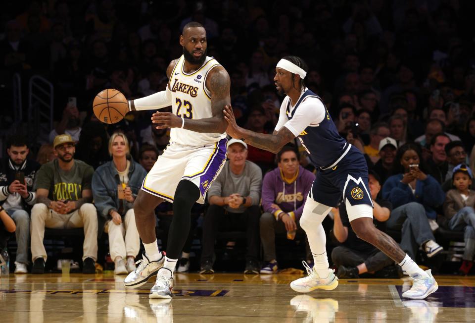 Los Angeles Lakers forward LeBron James (23) dribbles against Denver Nuggets guard Kentavious Caldwell-Pope (5) during the third quarter of Game 4.