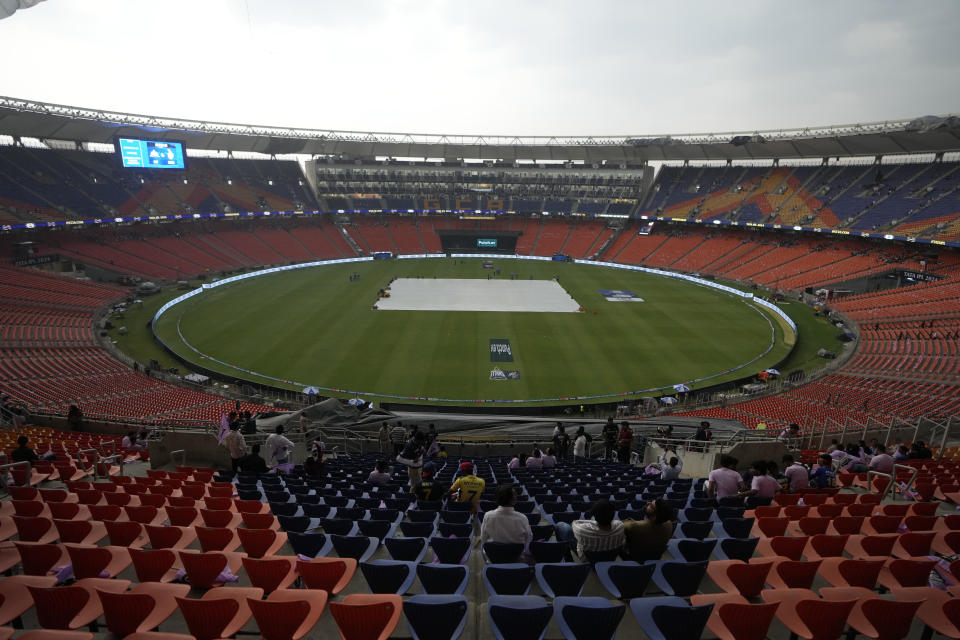 The pitch is covered due to bad weather and light rain before the start of Indian Premier League cricket match between Gujarat Titans and Kolkata Knight Riders at Narendra Modi stadium in Ahmedabad, India, Monday, May 13, 2024. (AP Photo/Ajit Solanki)