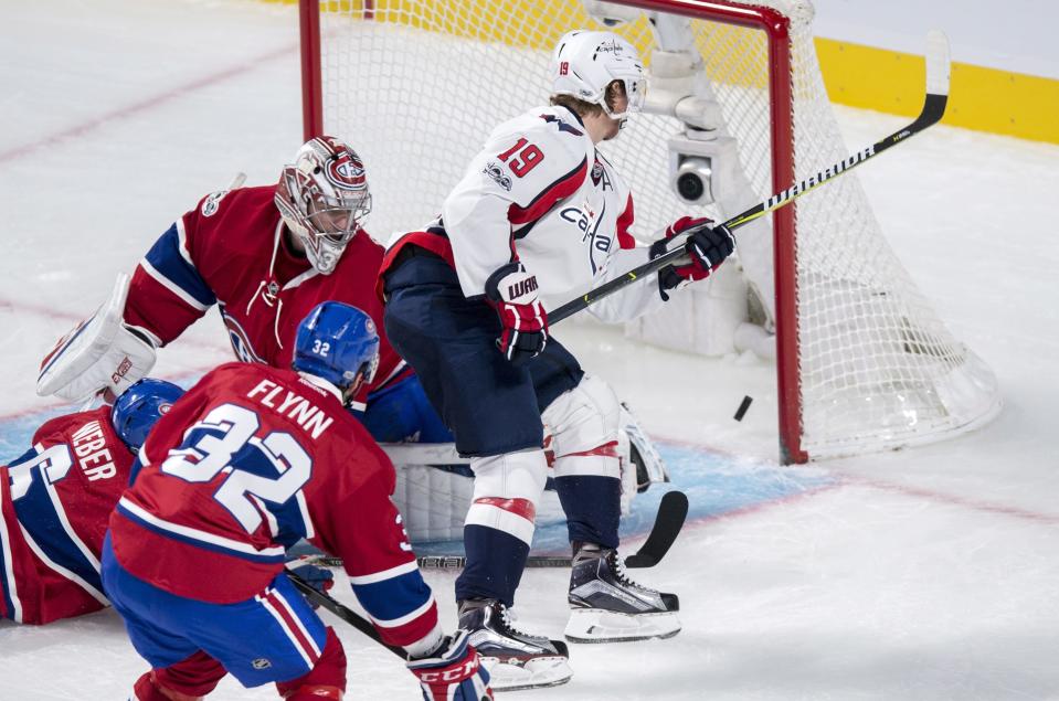 Washington Capitals center Nicklas Backstrom (19) scores past Montreal Canadiens goalie Carey Price (31) as center Brian Flynn (32) watches during the first period of an NHL hockey game Monday, Jan. 9, 2017, in Montreal. (Paul Chiasson/The Canadian Press via AP)